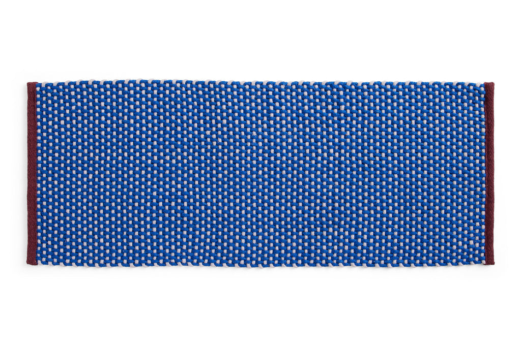 Royal blue long door mat rug by HAY with a textured surface, ideal for entryway decor and durability.